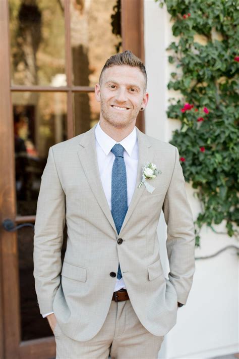 tan suit with blue tie.